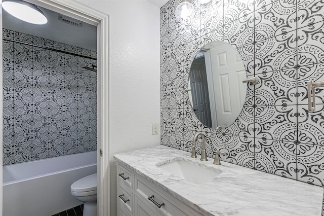 bathroom with washtub / shower combination, vanity, toilet, and visible vents