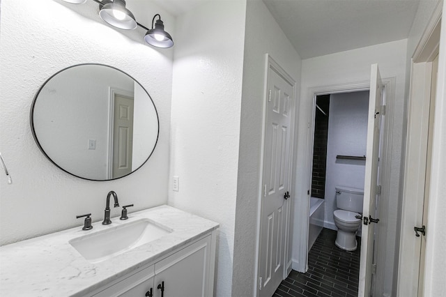 bathroom featuring toilet, tile patterned flooring, and vanity