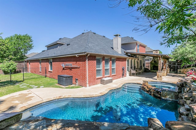 view of pool with a patio, a pool with connected hot tub, ceiling fan, a fenced backyard, and a lawn