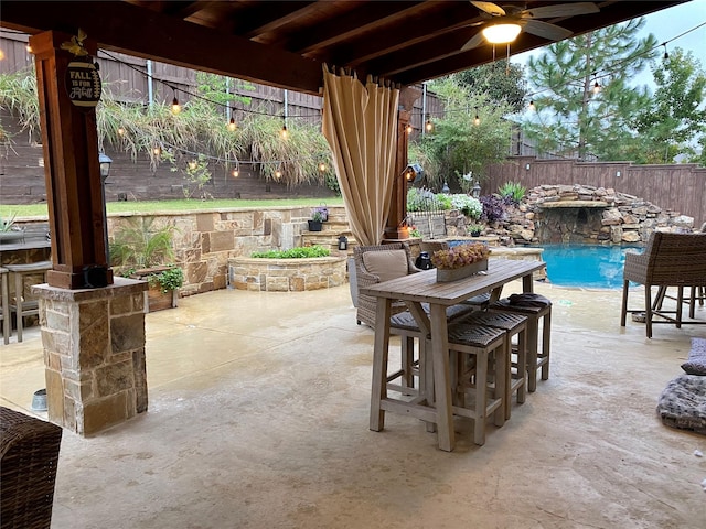 view of patio / terrace featuring ceiling fan, a fenced backyard, and a fenced in pool
