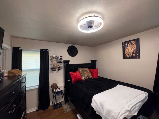 1207 Dearborn Dr, Richardson, TX 75080 - bedroom with a textured ceiling, dark wood-style flooring, and baseboards
