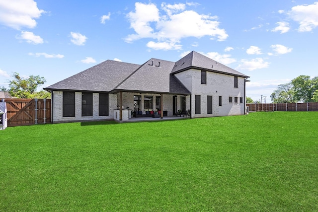 2214 Norwood St, Sherman, TX 75092 - back of house featuring a shingled roof, a fenced backyard, a yard, brick siding, and a patio area