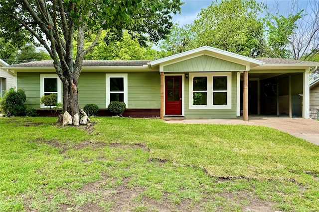 ranch-style home with driveway, a front yard, and an attached carport