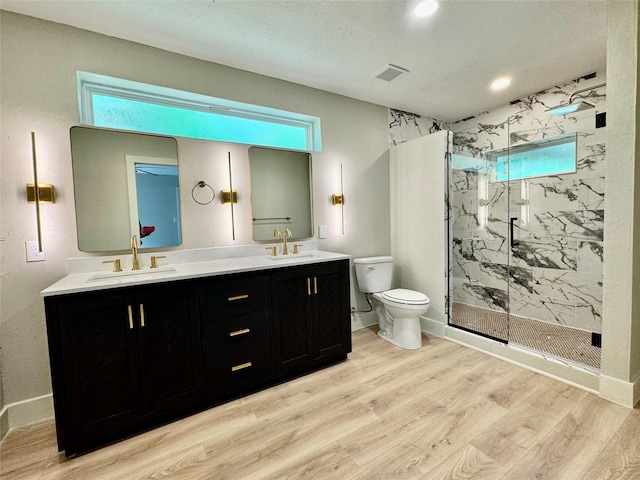 full bathroom featuring toilet, a sink, and wood finished floors