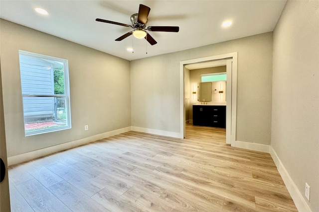 unfurnished bedroom featuring recessed lighting, baseboards, light wood finished floors, and connected bathroom