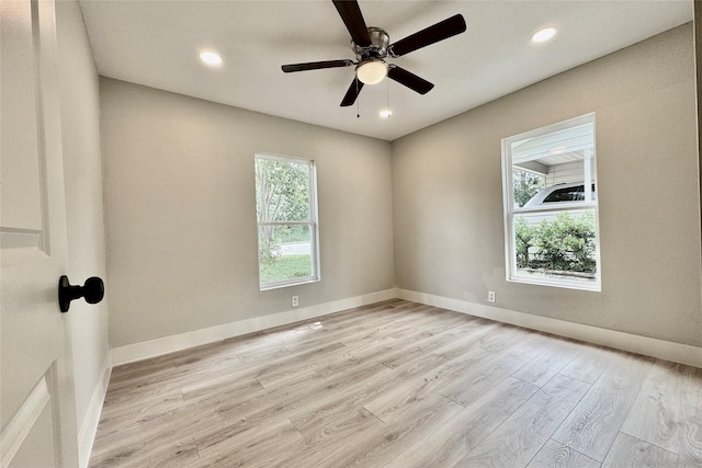spare room featuring light wood-style floors, recessed lighting, baseboards, and a ceiling fan