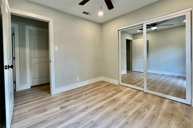 unfurnished bedroom featuring baseboards, ceiling fan, light wood-type flooring, and visible vents