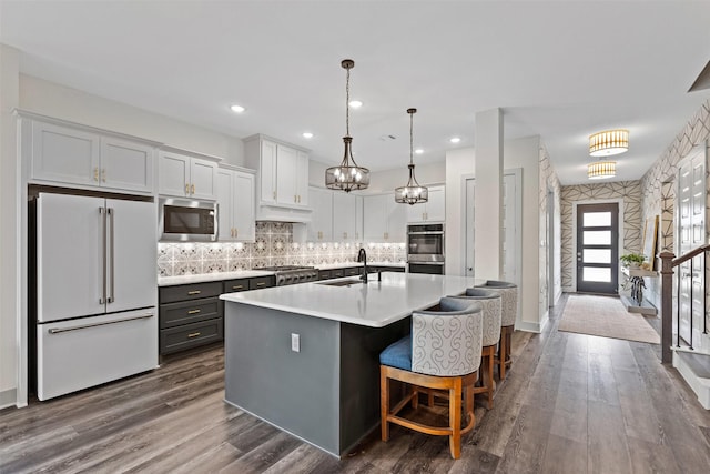 4801 Park View Pl, Arlington, TX 76005 - kitchen featuring appliances with stainless steel finishes, light countertops, white cabinets, dark wood-style flooring, and a sink