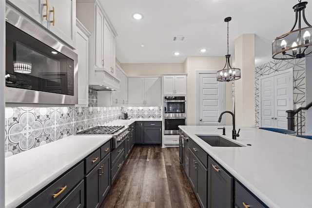 4801 Park View Pl, Arlington, TX 76005 - kitchen featuring a sink, a notable chandelier, premium range hood, white cabinets, and appliances with stainless steel finishes
