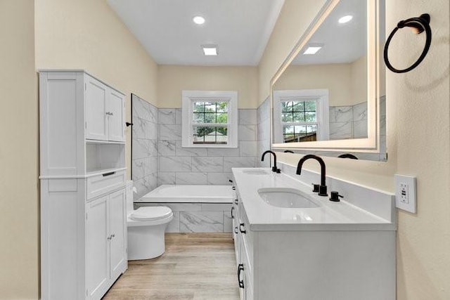 1301 N Sylvania Ave, Fort Worth, TX 76111 - bathroom with a bath, double vanity, a sink, and wood finished floors