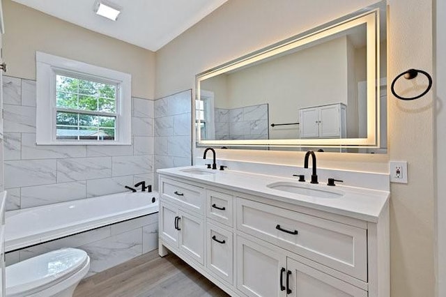 1301 N Sylvania Ave, Fort Worth, TX 76111 - full bathroom featuring wood finished floors, double vanity, a washtub, and a sink