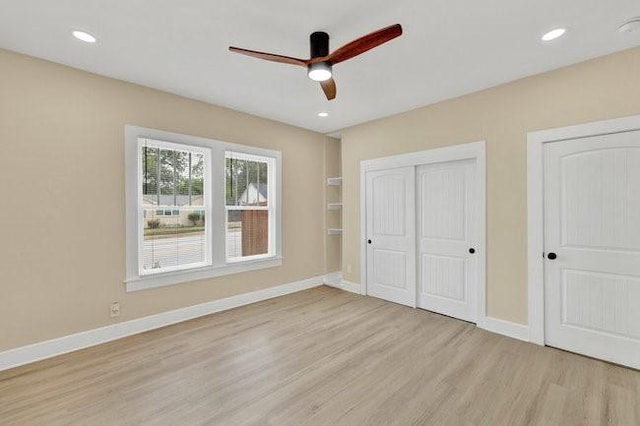 1301 N Sylvania Ave, Fort Worth, TX 76111 - unfurnished bedroom with light wood finished floors, two closets, ceiling fan, and baseboards