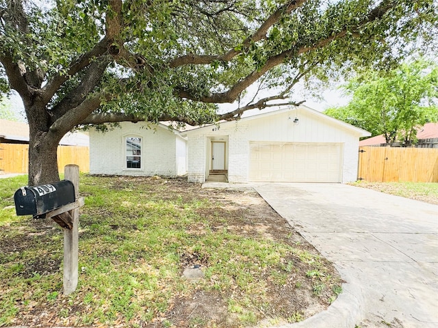 single story home with driveway, an attached garage, fence, and brick siding