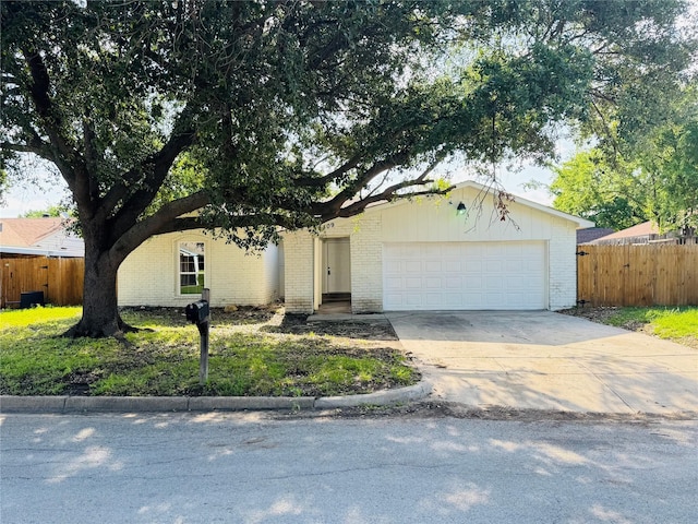 409 Bodart Ln, Fort Worth, TX 76108 - view of front of home with brick siding, driveway, and a garage