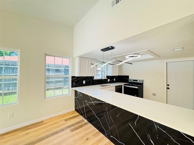 409 Bodart Ln, Fort Worth, TX 76108 - kitchen featuring black appliances, a sink, light wood-style flooring, white cabinetry, and light countertops