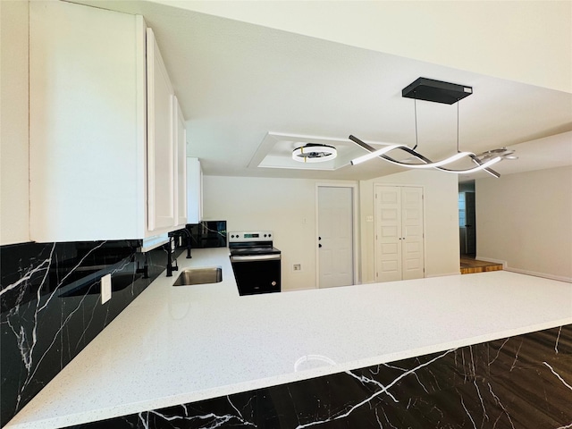 409 Bodart Ln, Fort Worth, TX 76108 - kitchen featuring electric stove, a sink, a peninsula, white cabinets, and marble finish flooring