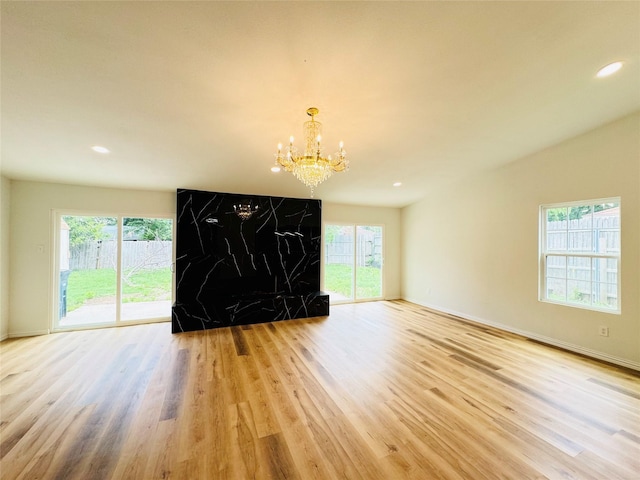 interior space with a chandelier, recessed lighting, wood finished floors, and baseboards