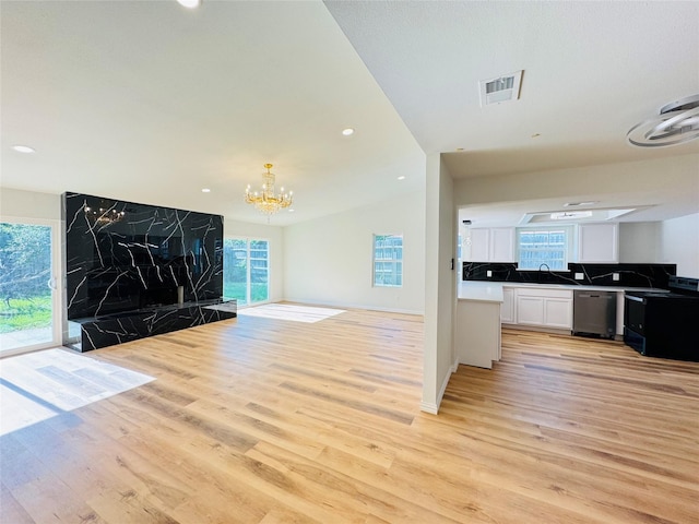 409 Bodart Ln, Fort Worth, TX 76108 - unfurnished living room with light wood finished floors, a sink, healthy amount of natural light, and recessed lighting