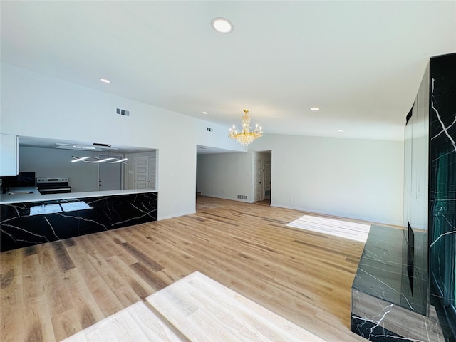 409 Bodart Ln, Fort Worth, TX 76108 - unfurnished living room with a chandelier, wood finished floors, recessed lighting, and baseboards