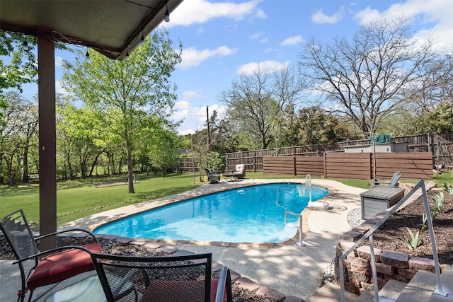 view of swimming pool with a lawn, a patio, a fenced in pool, and a fenced backyard