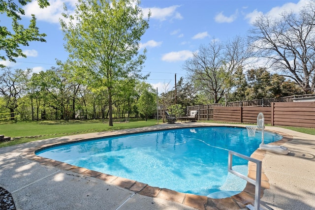 view of pool featuring fence, a yard, a patio area, and a fenced in pool