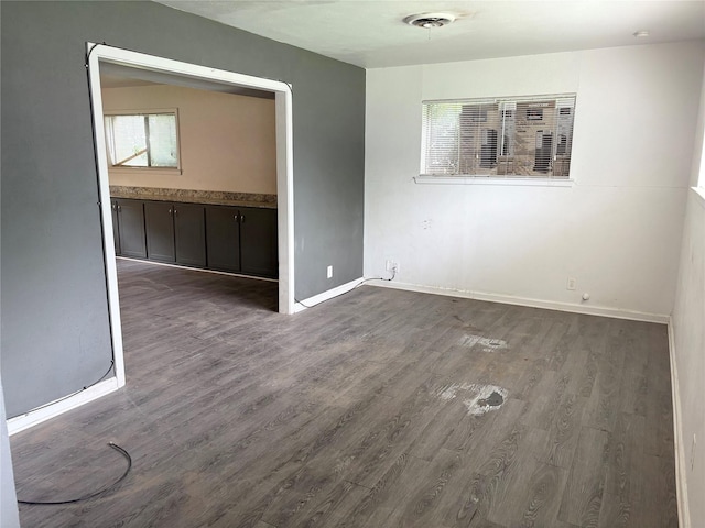 spare room with wood finished floors and baseboards