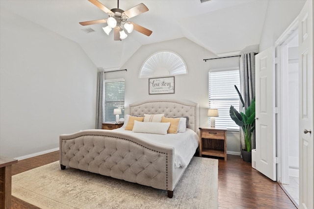 bedroom featuring baseboards, visible vents, wood finished floors, and multiple windows