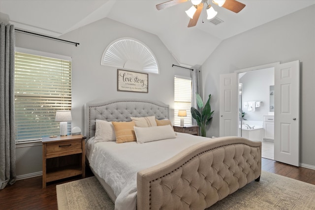 bedroom featuring dark wood-style flooring, ensuite bathroom, baseboards, a ceiling fan, and lofted ceiling