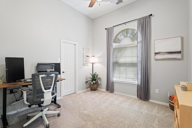 carpeted home office with visible vents, a ceiling fan, and baseboards