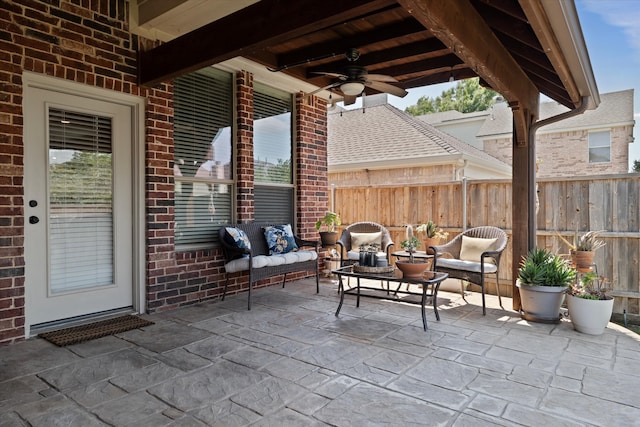 view of patio with an outdoor hangout area, ceiling fan, and fence