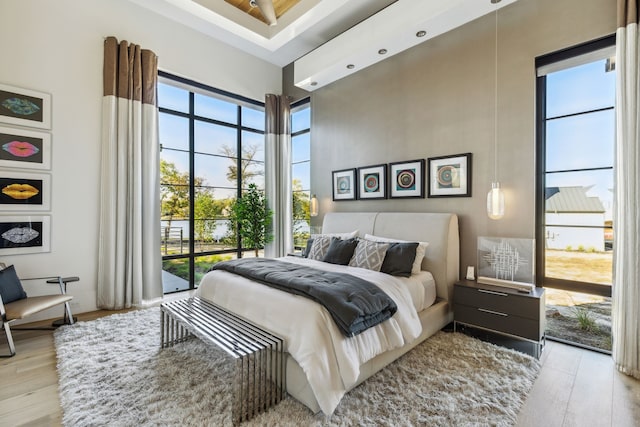 bedroom featuring a high ceiling and wood finished floors