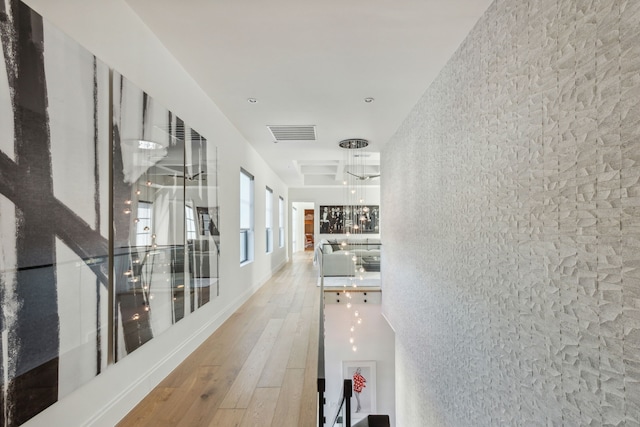 corridor featuring visible vents and hardwood / wood-style flooring