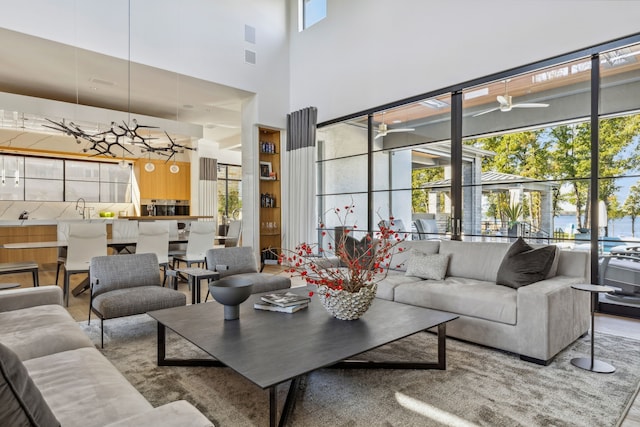 living area featuring ceiling fan and a high ceiling