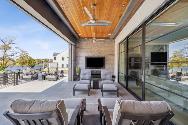 view of patio / terrace featuring a ceiling fan and an outdoor living space with a fireplace