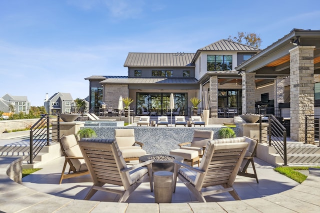 view of patio with an outdoor fire pit