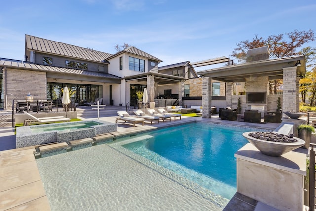 view of swimming pool featuring a fenced in pool, an outdoor living space with a fireplace, an in ground hot tub, and a patio area