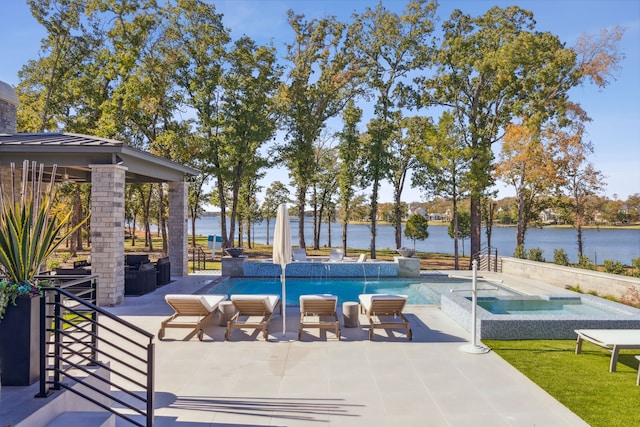 outdoor pool featuring a patio, a water view, and an in ground hot tub