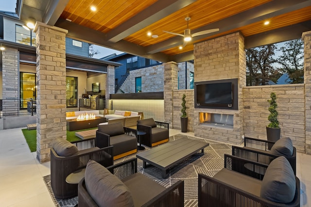 view of patio with an outdoor living space with a fireplace