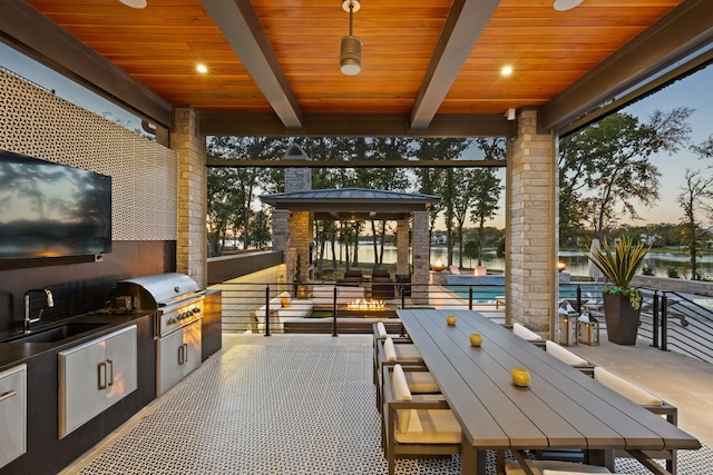 view of patio with a sink, area for grilling, a grill, a pool, and outdoor dining space