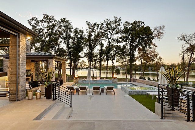 outdoor pool featuring a patio and a water view