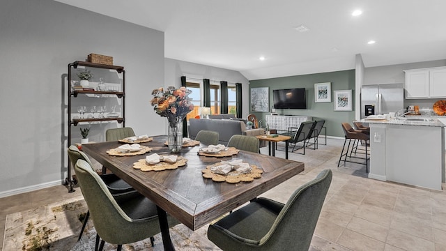 dining room featuring baseboards and recessed lighting