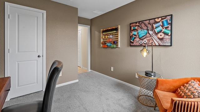 carpeted office space featuring baseboards