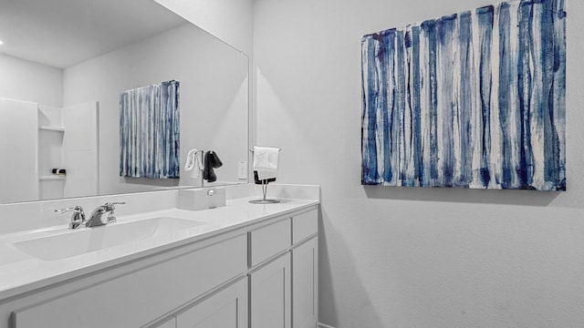full bathroom featuring double vanity and a sink