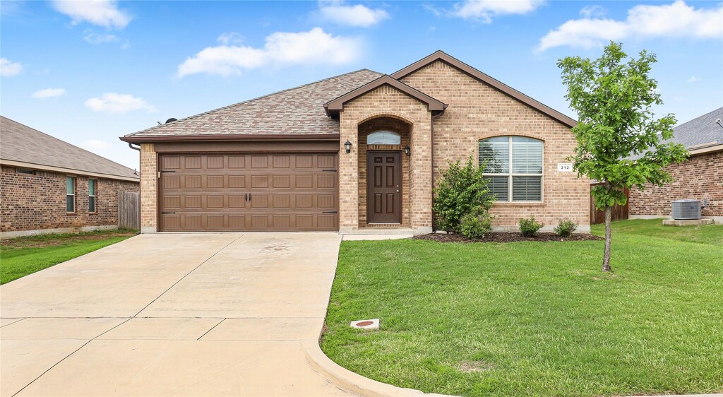 212 Meadowlands Dr, Ponder, TX 76259 - view of front of house featuring brick siding, a shingled roof, a garage, driveway, and a front yard