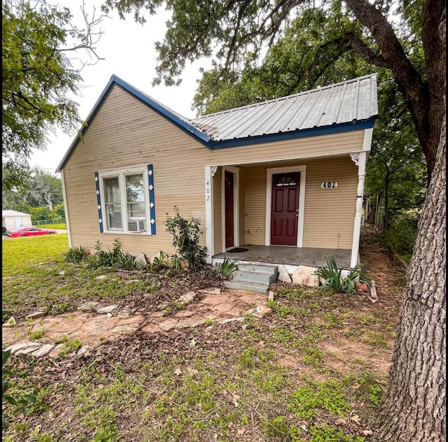 view of front of property featuring a porch and metal roof