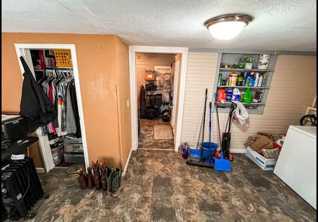 laundry room with hookup for a washing machine, a textured ceiling, and laundry area