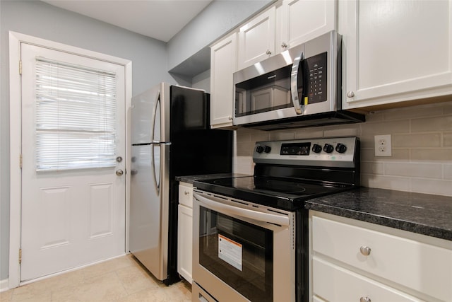 kitchen with appliances with stainless steel finishes, decorative backsplash, and white cabinetry
