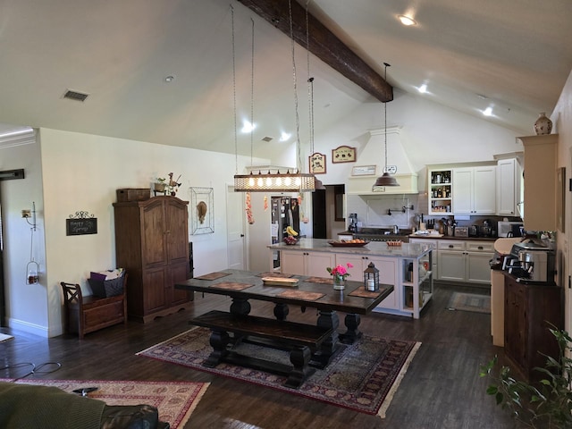 dining space with visible vents, dark wood finished floors, beam ceiling, and high vaulted ceiling
