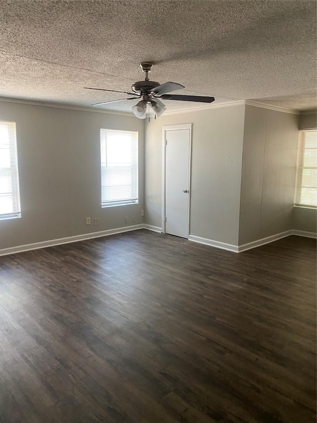 empty room with a healthy amount of sunlight, a textured ceiling, and crown molding
