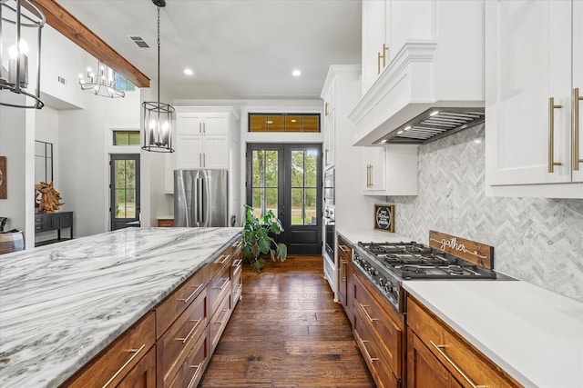 502 Vz County Road 1915, Fruitvale, TX 75127 - kitchen featuring stainless steel appliances, a notable chandelier, tasteful backsplash, white cabinets, and dark wood finished floors